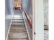 Carpeted stairway featuring wood handrail leading to additional living space at 1625 Saint Paul Church Rd, Salisbury, NC 28146