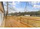 Back deck with wooden planking overlooking a grassy yard and distant trees under a blue sky at 1641 Knoll Dr, Vale, NC 28168