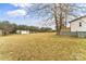 Grassy backyard featuring a shed and wooden fencing with a view of a home at 1641 Knoll Dr, Vale, NC 28168
