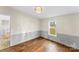 Bedroom with hardwood floors, fresh paint, and a sunlit window offering a pleasant view at 1641 Knoll Dr, Vale, NC 28168