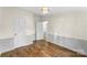 Well-lit bedroom featuring hardwood floors and paneled wainscoting at 1641 Knoll Dr, Vale, NC 28168