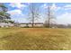View of the home with a large yard, small porch, and blue sky at 1641 Knoll Dr, Vale, NC 28168