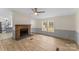 Inviting living room showcasing a brick fireplace and bright natural light from the windows at 1641 Knoll Dr, Vale, NC 28168