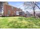 Spacious backyard featuring a brick home, screened-in porch, and inviting deck area at 16417 Grapperhall Dr, Huntersville, NC 28078