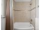 Updated bathroom featuring a shower-tub combination with tiled walls and a shower curtain at 16417 Grapperhall Dr, Huntersville, NC 28078