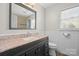 Bathroom with black vanity with marble countertop and window allowing for natural light at 16417 Grapperhall Dr, Huntersville, NC 28078
