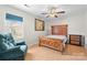 Cozy bedroom with a comfortable armchair, wooden bed frame, and natural light from the window at 16417 Grapperhall Dr, Huntersville, NC 28078