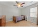 Modest bedroom with a ceiling fan, dresser, and natural light from the window with blinds at 16417 Grapperhall Dr, Huntersville, NC 28078