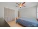 Bedroom features a ceiling fan, closet doors and a bed with blue comforter at 16417 Grapperhall Dr, Huntersville, NC 28078