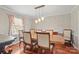 Elegant dining room with hardwood floors, stylish lighting, and seating for six at 16417 Grapperhall Dr, Huntersville, NC 28078