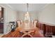 Spacious dining room featuring hardwood floors, elegant lighting, and ample serving space at 16417 Grapperhall Dr, Huntersville, NC 28078