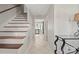 Inviting hallway with staircase and tile flooring, leading to various rooms in the home at 16417 Grapperhall Dr, Huntersville, NC 28078