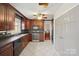 Kitchen with dark wood cabinets, stainless steel appliances, and tiled floors at 16417 Grapperhall Dr, Huntersville, NC 28078