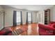 Comfortable living room with hardwood floors, large windows, and cozy seating area at 16417 Grapperhall Dr, Huntersville, NC 28078