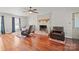 Bright living room with a brick fireplace, hardwood floors, and comfortable seating at 16417 Grapperhall Dr, Huntersville, NC 28078