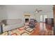 Living room features hardwood floors, fireplace, ceiling fan, and comfortable seating at 16417 Grapperhall Dr, Huntersville, NC 28078