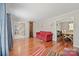 Spacious living room with hardwood floors, open layout, and view to the dining room at 16417 Grapperhall Dr, Huntersville, NC 28078
