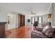 Open living area with hardwood floors, large windows, and brick fireplace at 16417 Grapperhall Dr, Huntersville, NC 28078