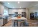 Bright kitchen with white cabinetry, stainless appliances, island seating, and open layout at 1700 Ivey Ct, Maiden, NC 28650
