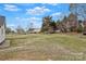 Expansive yard with mature trees surrounding the property at 207 Silver Creek Ln, Shelby, NC 28152