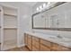 Bathroom with double sinks, wood cabinets, and a mirror with wood trim at 207 Silver Creek Ln, Shelby, NC 28152