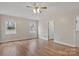 Bright bedroom boasts hardwood floors, a ceiling fan, and plenty of natural light from two windows at 207 Silver Creek Ln, Shelby, NC 28152