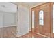 Inviting entryway with wood door and sidelights, plus a glimpse of the room with beautiful wood-look flooring at 207 Silver Creek Ln, Shelby, NC 28152