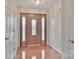 Welcoming foyer with a decorative wood door, sidelights, and gleaming hardwood floors at 207 Silver Creek Ln, Shelby, NC 28152
