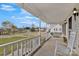 Inviting front porch with a porch swing and rocking chair overlooking the community at 207 Silver Creek Ln, Shelby, NC 28152