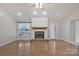 Living room showcases a brick fireplace, large window, and hardwood floors at 207 Silver Creek Ln, Shelby, NC 28152