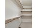 Large walk-in closet features wooden railings and shelves for clothing and storage at 207 Silver Creek Ln, Shelby, NC 28152