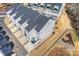 New townhomes with gray siding, dark roofs, and individual driveways and a stone foundation are visible in this aerial view at 208 Emerson Ave, Charlotte, NC 28204