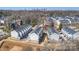 Aerial view showcases modern townhomes against a backdrop of the Charlotte skyline on a bright, sunny day at 208 Emerson Ave, Charlotte, NC 28204