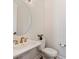 Powder room with a decorative mirror, pedestal sink with gold fixtures and neutral wall color at 208 Emerson Ave, Charlotte, NC 28204