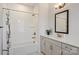 Bathroom with vanity, bathtub, shower, and decorative mirror at 208 Emerson Ave, Charlotte, NC 28204