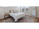 Bright bedroom with large windows, neutral decor, and stylish area rug at 208 Emerson Ave, Charlotte, NC 28204