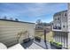 View of the outdoor deck with plants, black metal railing and space to relax and enjoy the view at 208 Emerson Ave, Charlotte, NC 28204