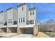 Townhome with neutral siding, brick accents, and a private balcony at 208 Emerson Ave, Charlotte, NC 28204