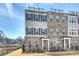 Modern townhome with brick facade, shutters, and rooftop deck at 208 Emerson Ave, Charlotte, NC 28204