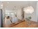 Bright, open-concept kitchen with island, stainless appliances, and dining area with chandelier at 208 Emerson Ave, Charlotte, NC 28204