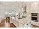 Spacious kitchen featuring a large island with granite countertops and open shelving and stainless steel appliances at 208 Emerson Ave, Charlotte, NC 28204