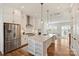 Open concept kitchen with a large island, stainless steel appliances, and white cabinetry at 208 Emerson Ave, Charlotte, NC 28204