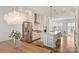 Bright kitchen with stainless steel appliances, granite countertops, white cabinets, and an open layout to the dining area at 208 Emerson Ave, Charlotte, NC 28204
