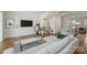 Bright living room with hardwood floors, neutral decor, and an open layout leading to the kitchen and stairs at 208 Emerson Ave, Charlotte, NC 28204
