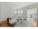 Spacious living room with modern sectional couch and light-filled windows at 208 Emerson Ave, Charlotte, NC 28204