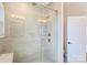 Bathroom showcasing tiled shower, glass doors, and updated fixtures at 208 Emerson Ave, Charlotte, NC 28204