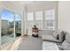 Bright sunroom with seating area, large windows, and sliding door to balcony at 208 Emerson Ave, Charlotte, NC 28204