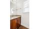 Bathroom vanity featuring granite counters, wood cabinets, and natural light at 2251 Barrowcliffe Nw Dr, Concord, NC 28027
