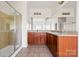 Bathroom with a glass-enclosed shower, double vanity with granite countertops, and tile flooring at 2251 Barrowcliffe Nw Dr, Concord, NC 28027