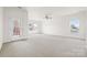 Large bonus room filled with light from several windows and door access to the outside at 2251 Barrowcliffe Nw Dr, Concord, NC 28027